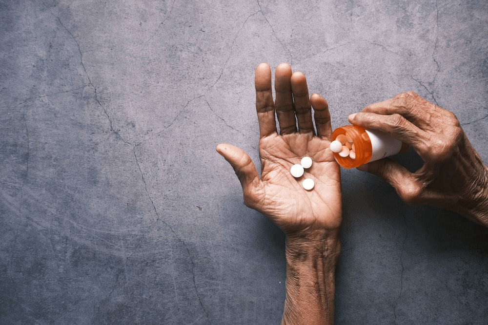 person holding pills