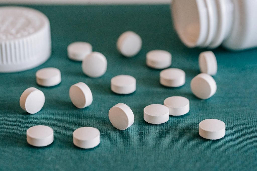 White pills spilled out of prescription bottle