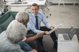 a licensed Medicare insurance agent explaining different Medicare options to seniors.