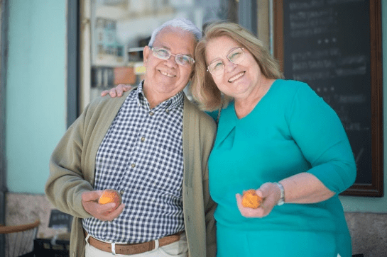 an elderly couple smiling.