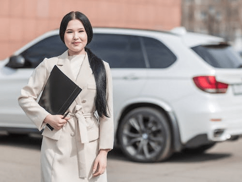 an insurance agent holding a black folder.
