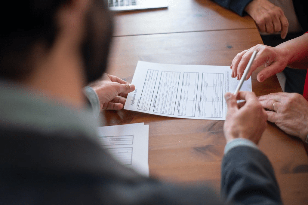 An agent handing a pen to a client