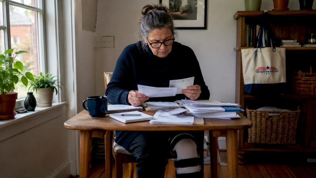 Disabled woman reviewing Medicare Part D papers at home
