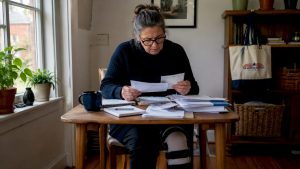 Disabled woman reviewing Medicare Part D papers at home