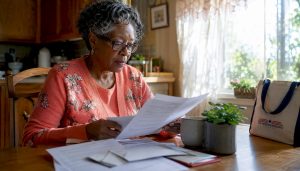 Senior woman reviewing Medicare plans at home