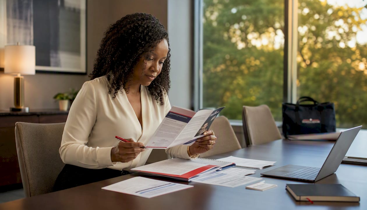 Benefits administrator reviewing Medicare coordination of benefits documents