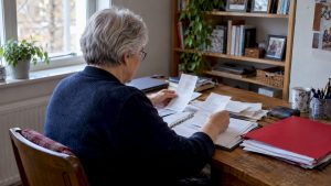 Older adult sorting long-term care tax records