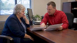 Senior comparing final expense policy options with agent