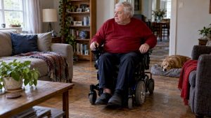 Older adult using a power wheelchair at home