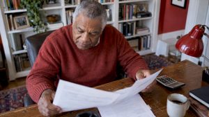 Retired man comparing income option papers