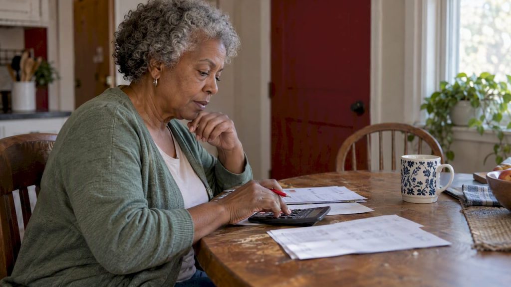 Woman comparing health account figures at home
