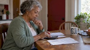 Woman comparing health account figures at home