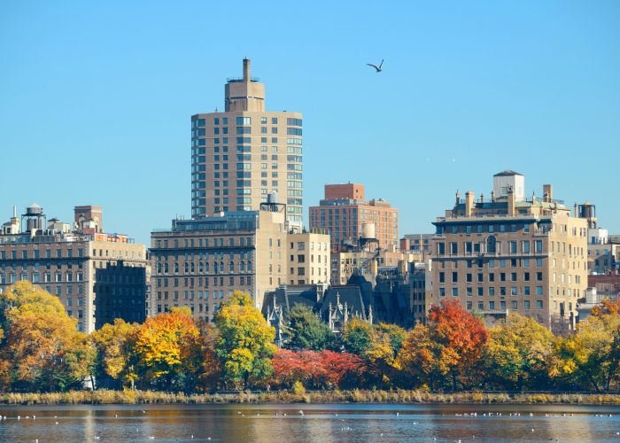 Central park Manhattan east side luxury building over lake in Autumn in New York City.