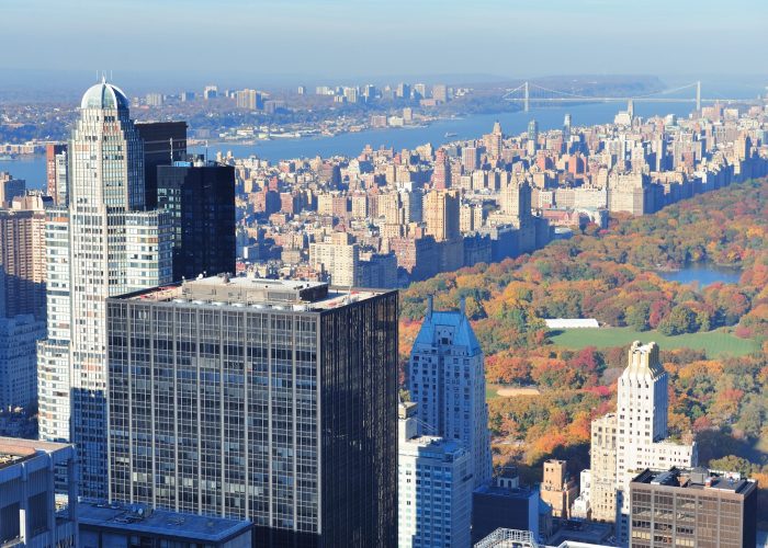 New York City skyscrapers in midtown Manhattan aerial panorama view in the day with Central Park and colorful foliage in Autumn.